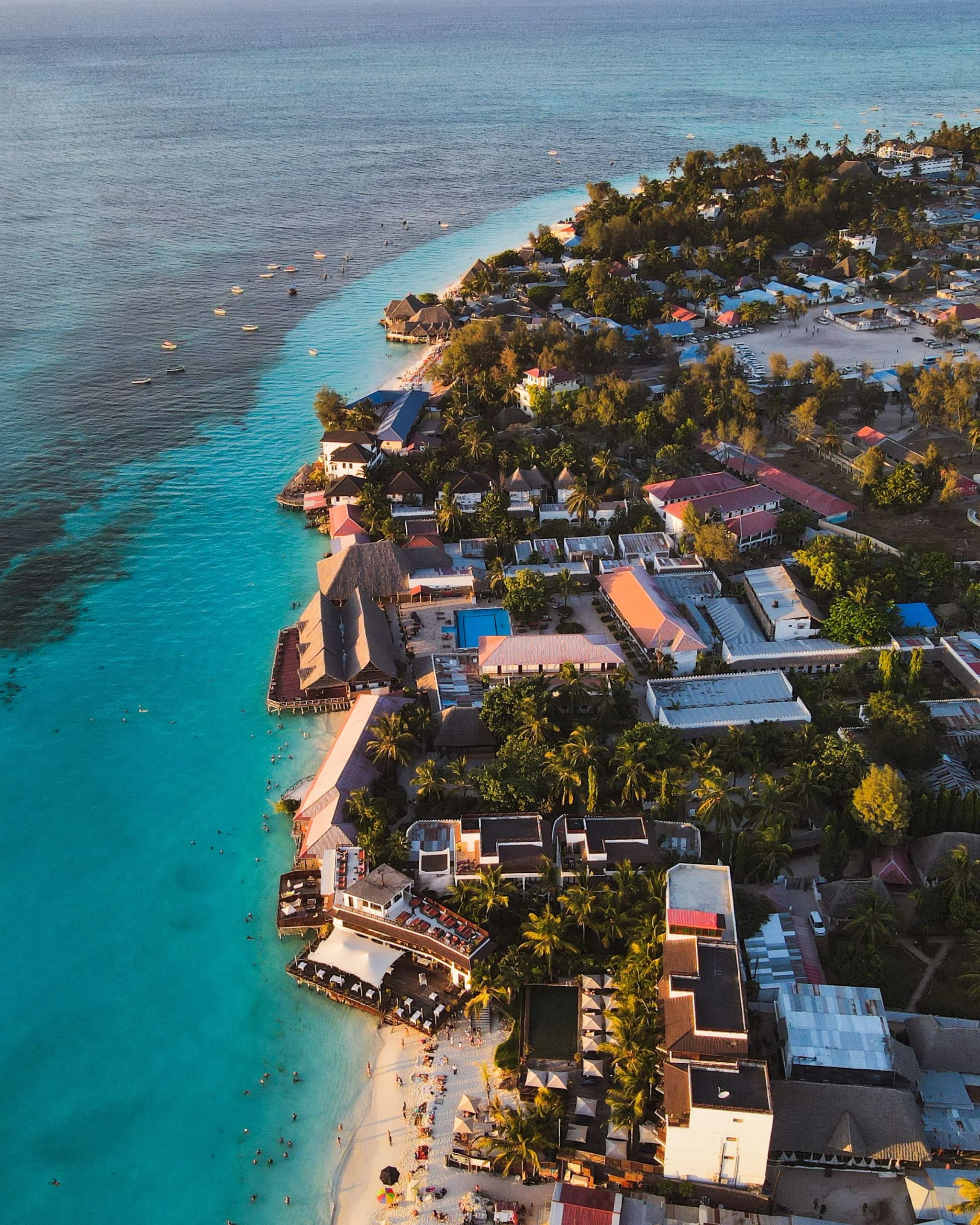 Aerial view of beach hotels along a turquoise coastline